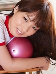 Maho Kiruma in sports equipment plays with ball on desk Maho Kiruma in sports equipment plays with ball on desk