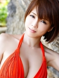 Japanese Yumiko Shaku in orange bath suit takes a walk on the beach Japanese Yumiko Shaku in orange bath suit takes a walk on the beach